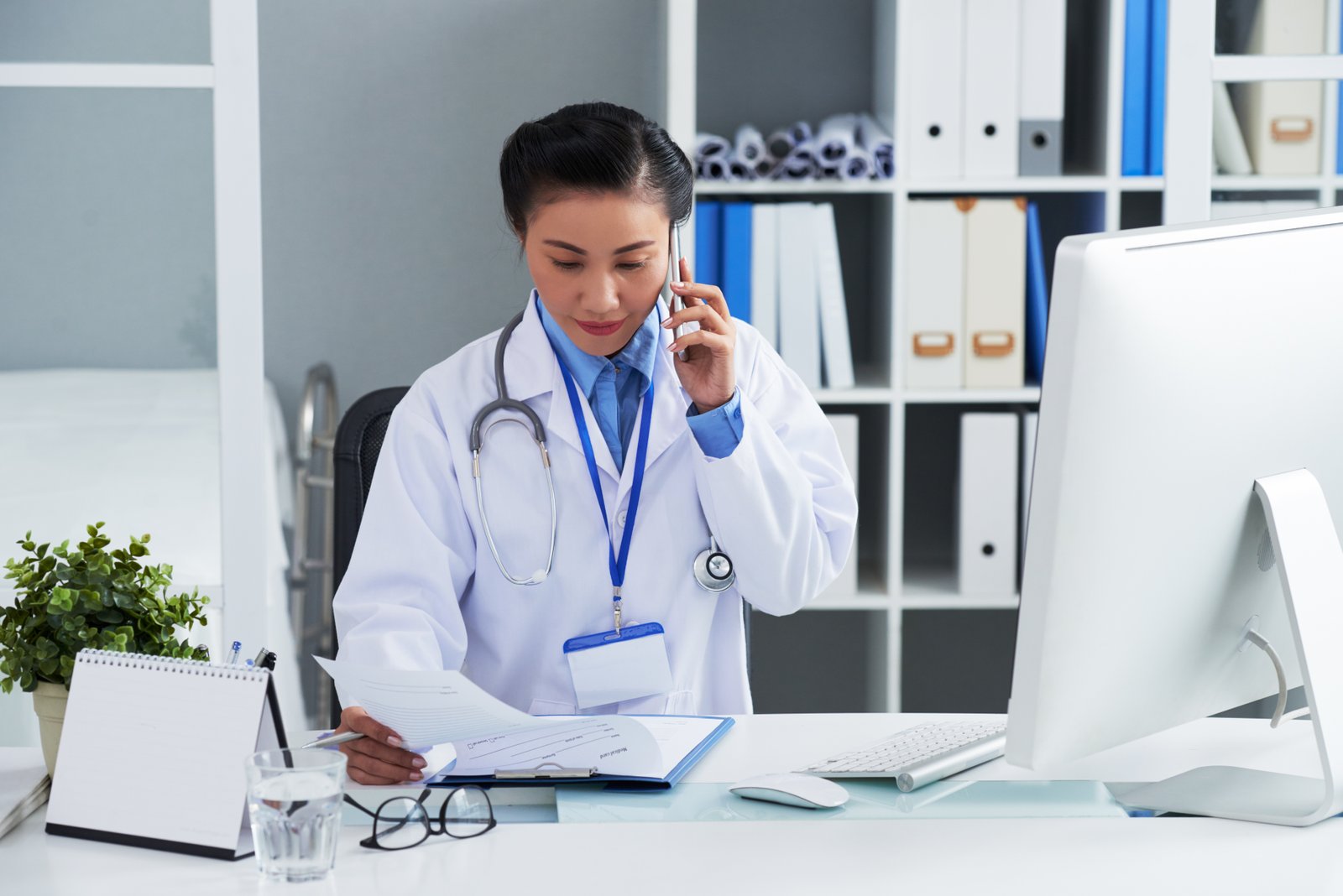 asian-female-doctor-sitting-desk-office-calling-mobile-phone.jpg